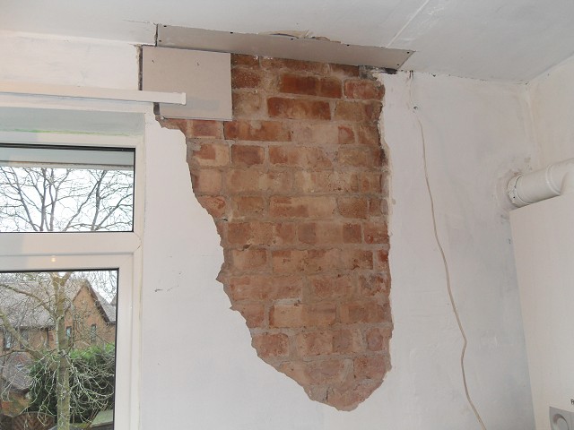 Loose plaster removed from wall.