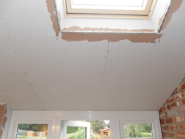 Plasterboard ceiling built-up around joists and Velux.